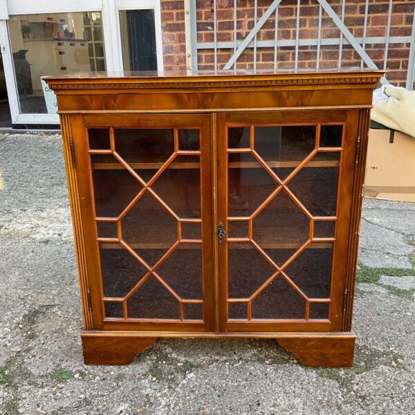 Antique burr walnut display cabinet with glass doors.