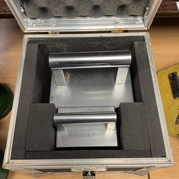 Silver flight case containing 5kg and 20kg calibration weights.