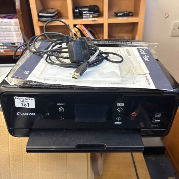 Canon TS 6050 home printer with manual and charger.