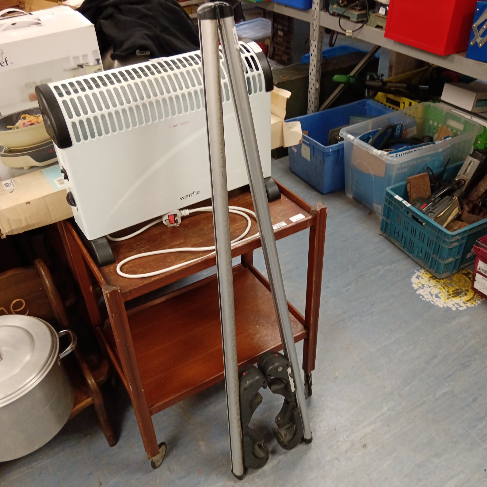 Silver car roof bars shown on a workbench.
