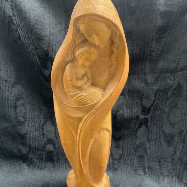 Front view of a carved wooden Madonna and Child statue.