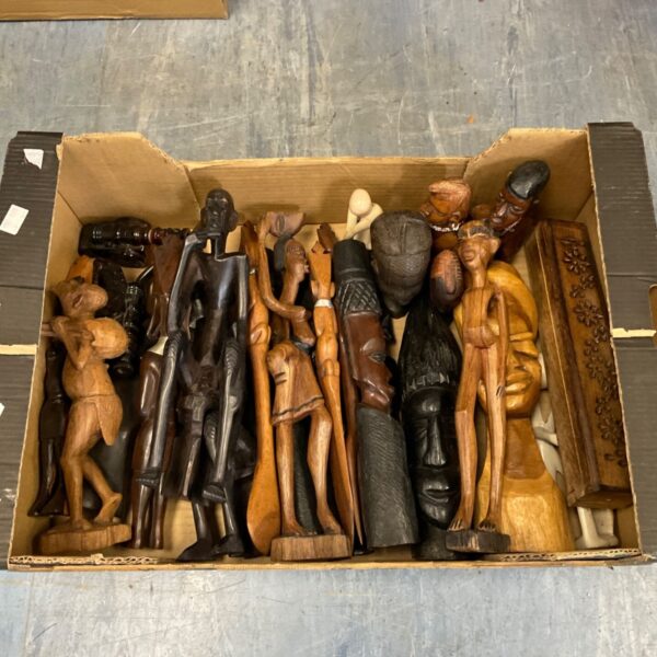 Large collection of carved wooden African figurines on display.