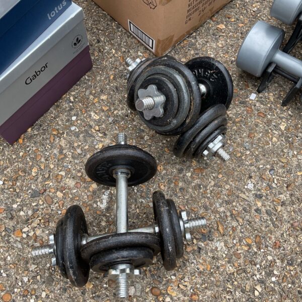 Pair of vintage cast iron dumbbells for strength training.