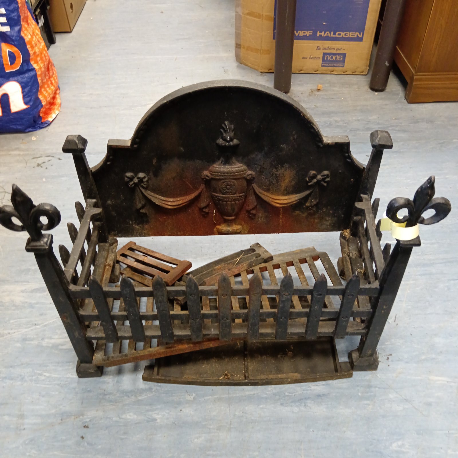 Antique cast iron fireplace grate with Fleur de lis details.