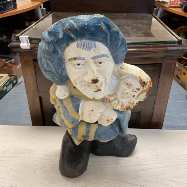 Vintage cast iron doorstop of a detailed puppeteer figure.