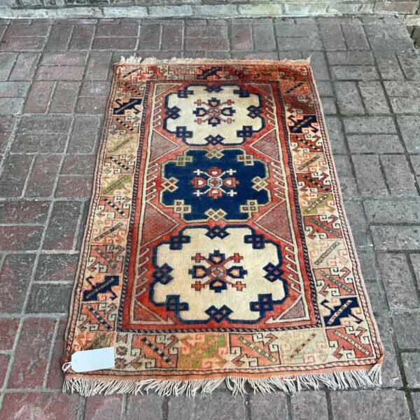 Vibrant handknotted Caucasian rug with geometric patterns.