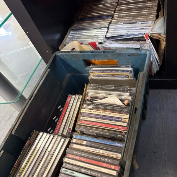 Two boxes filled with a collection of music CDs.