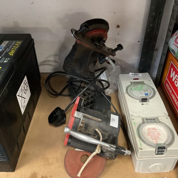 Black electric chainsaw chain sharpener, model XY11F, on a workbench.