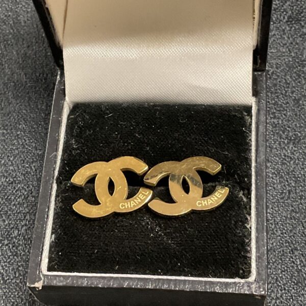 Vintage Chanel Double C logo earrings in a leather box.