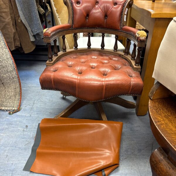 Vintage Chesterfield captain's chair with leather upholstery and swivel base.