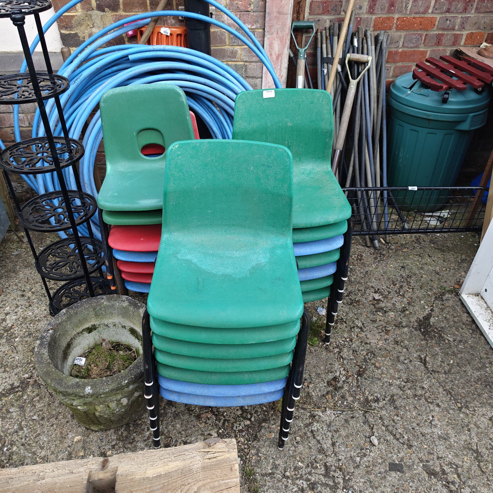 Stack of brightly coloured children's school stacking chairs.