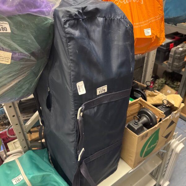 Blue children’s travel cot folded for storage.