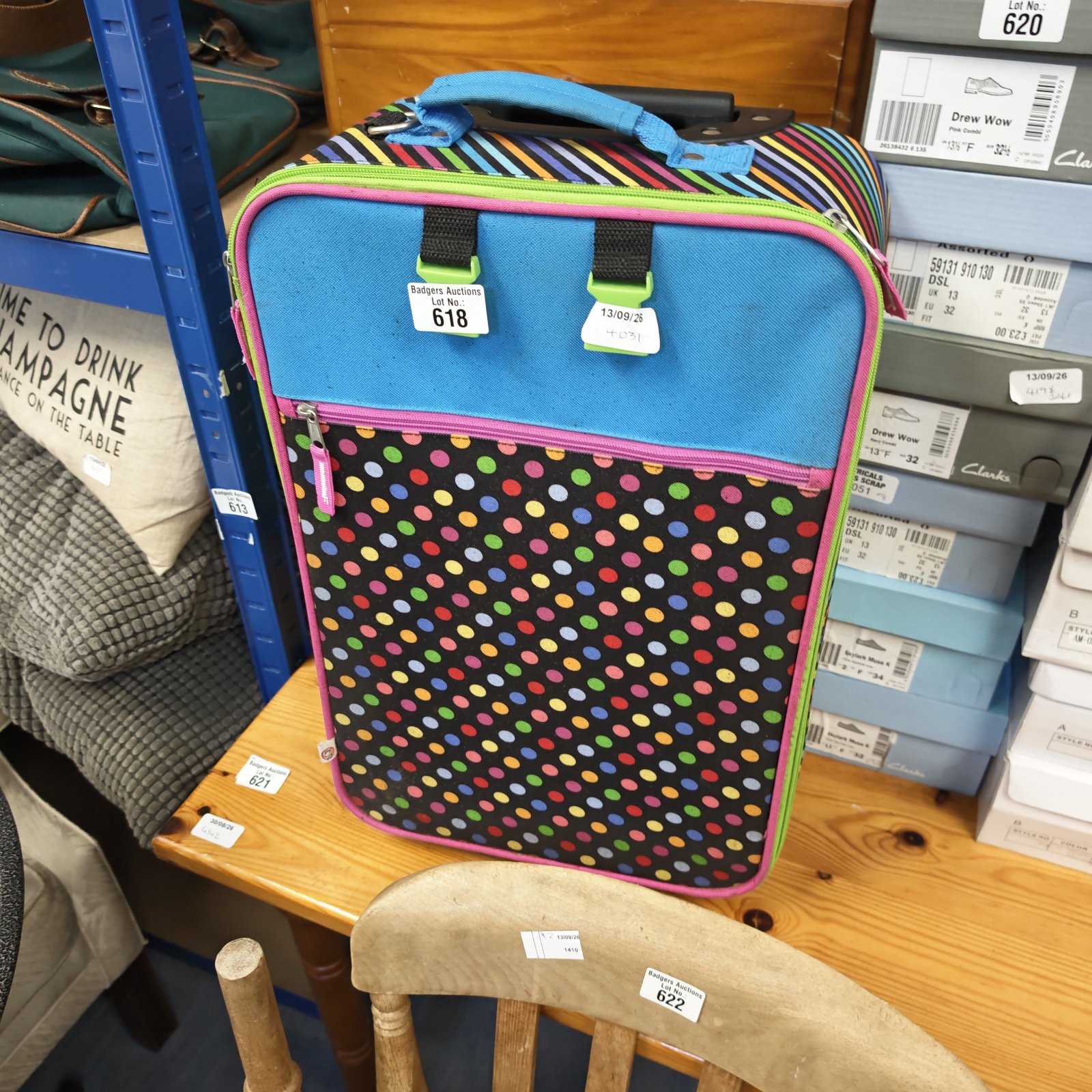 Colourful pokerdot child's wheeled suitcase for travel.
