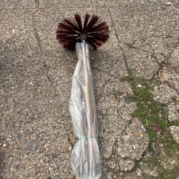 Chimney sweep kit with brush and segmented pole for cleaning.