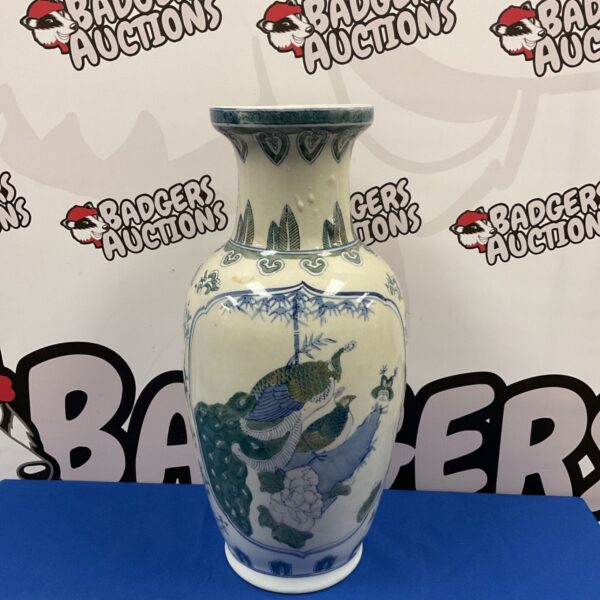 Large Chinese blue and white peacock vase with green accents.
