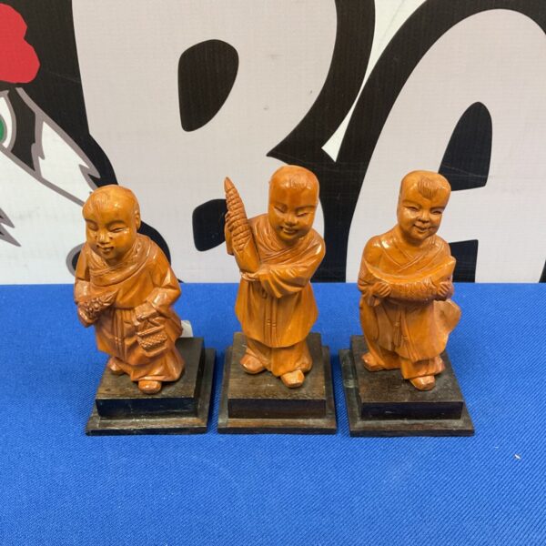 Vintage Chinese boxwood carvings of three children figurines.