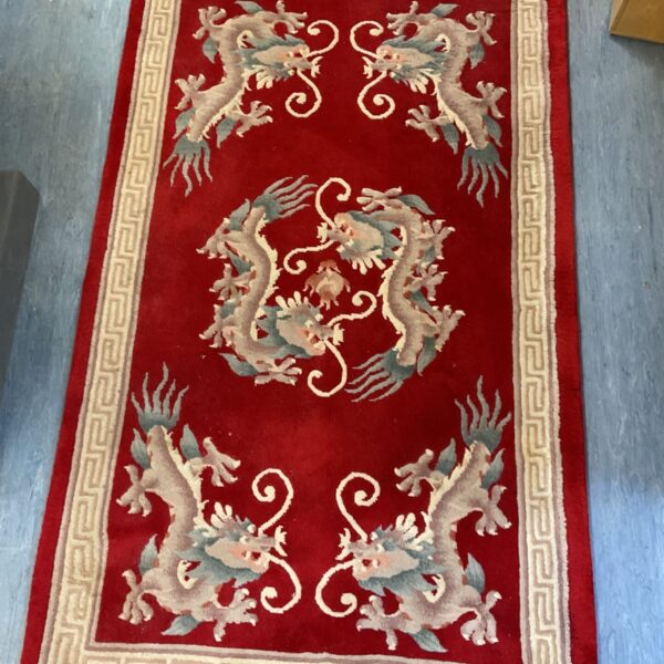 Vintage Chinese red wool rug with detailed dragon design.