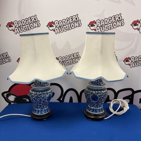 Pair of vintage Chinese porcelain table lamps with blue and white design.