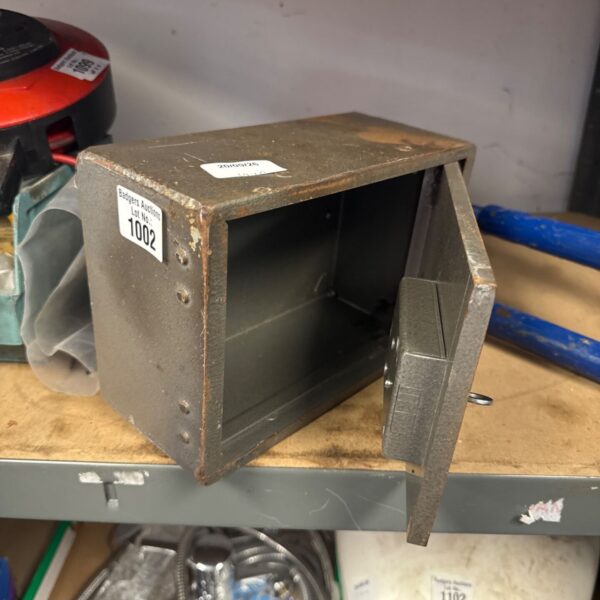 Vintage Chubb wall safe with key, ideal for secure storage.