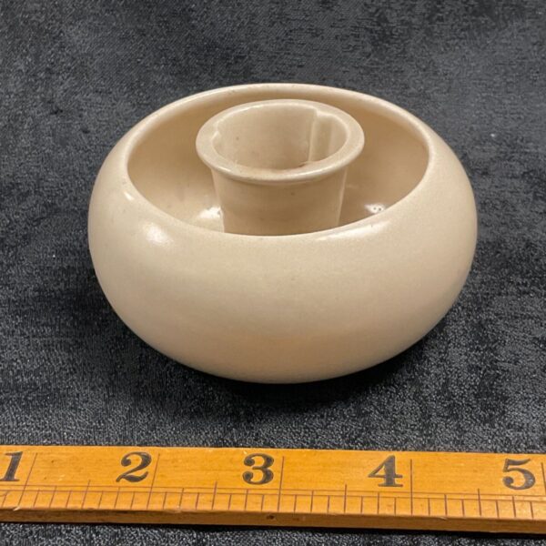 Vintage Clarice Cliff candle holder with ruler for scale.