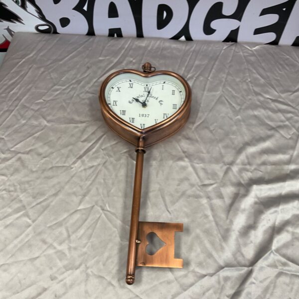 Vintage Colonial Key Shaped Wall Clock with Roman numerals.