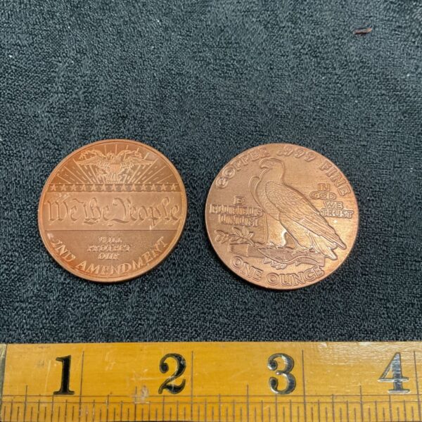 Copper round coin featuring the 2nd amendment scales of justice design.