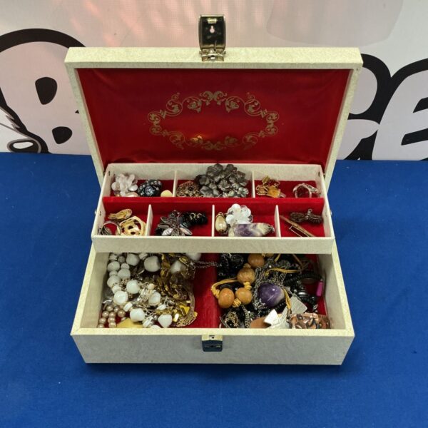 Costume jewellery box filled with vintage and modern fashion pieces.