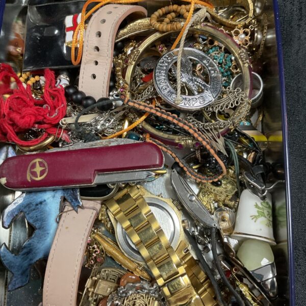Mixed lot of vintage costume jewellery, watches, and a pocket knife in a tin.