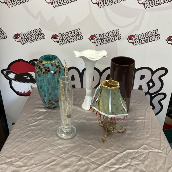Vintage cracked glass vase with table items for display.