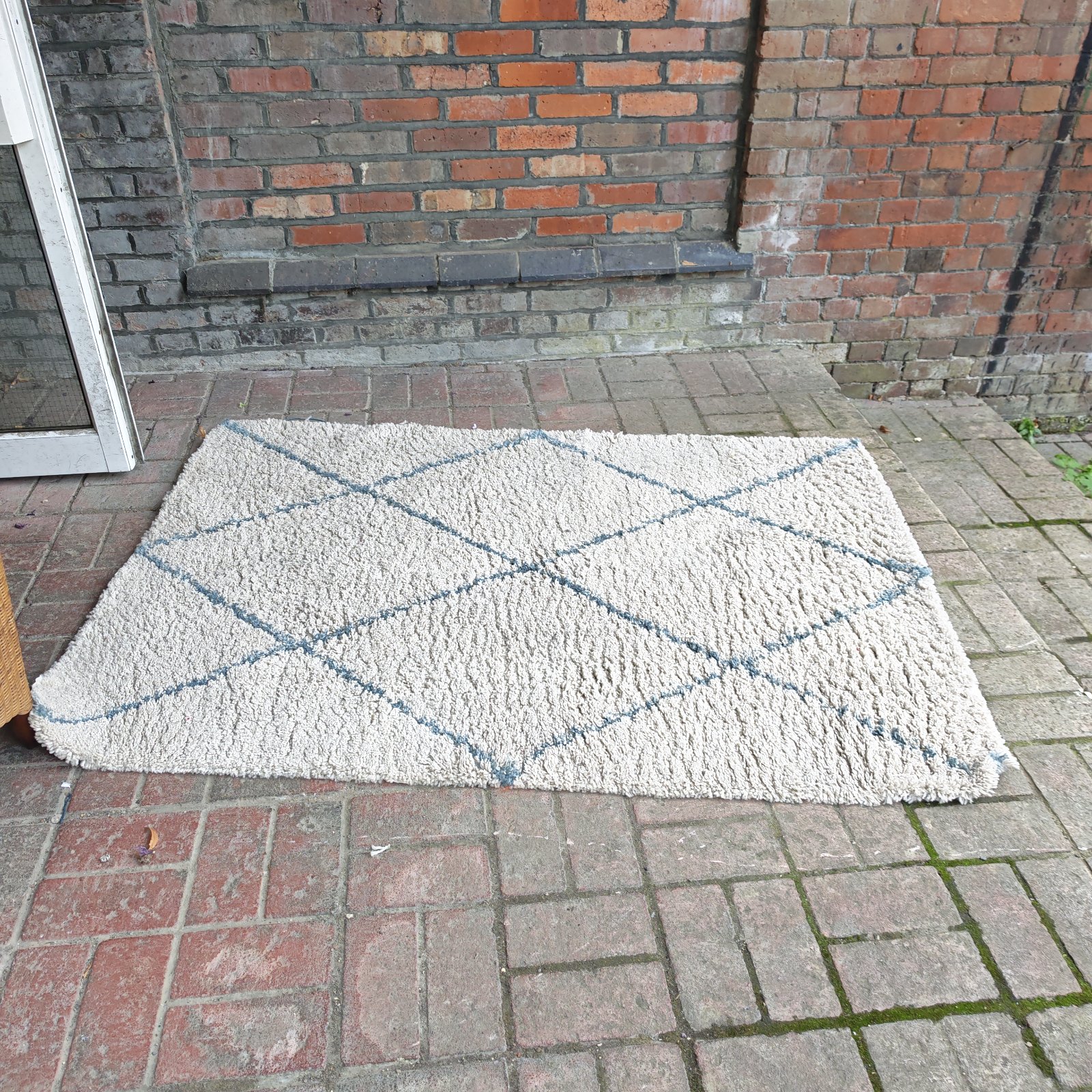 Cream and blue cross patterned rug for home decor.