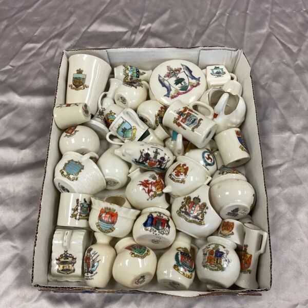 Large collection of vintage crested ware pottery with heraldic crests.