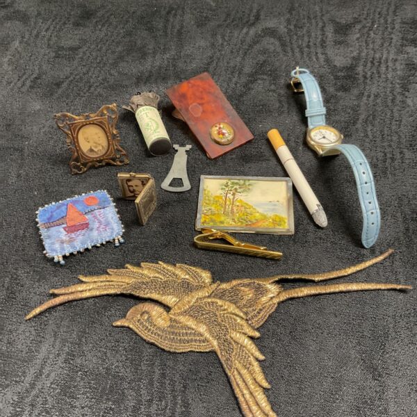 Vintage curios tray featuring a miniature watercolour and tapestry.