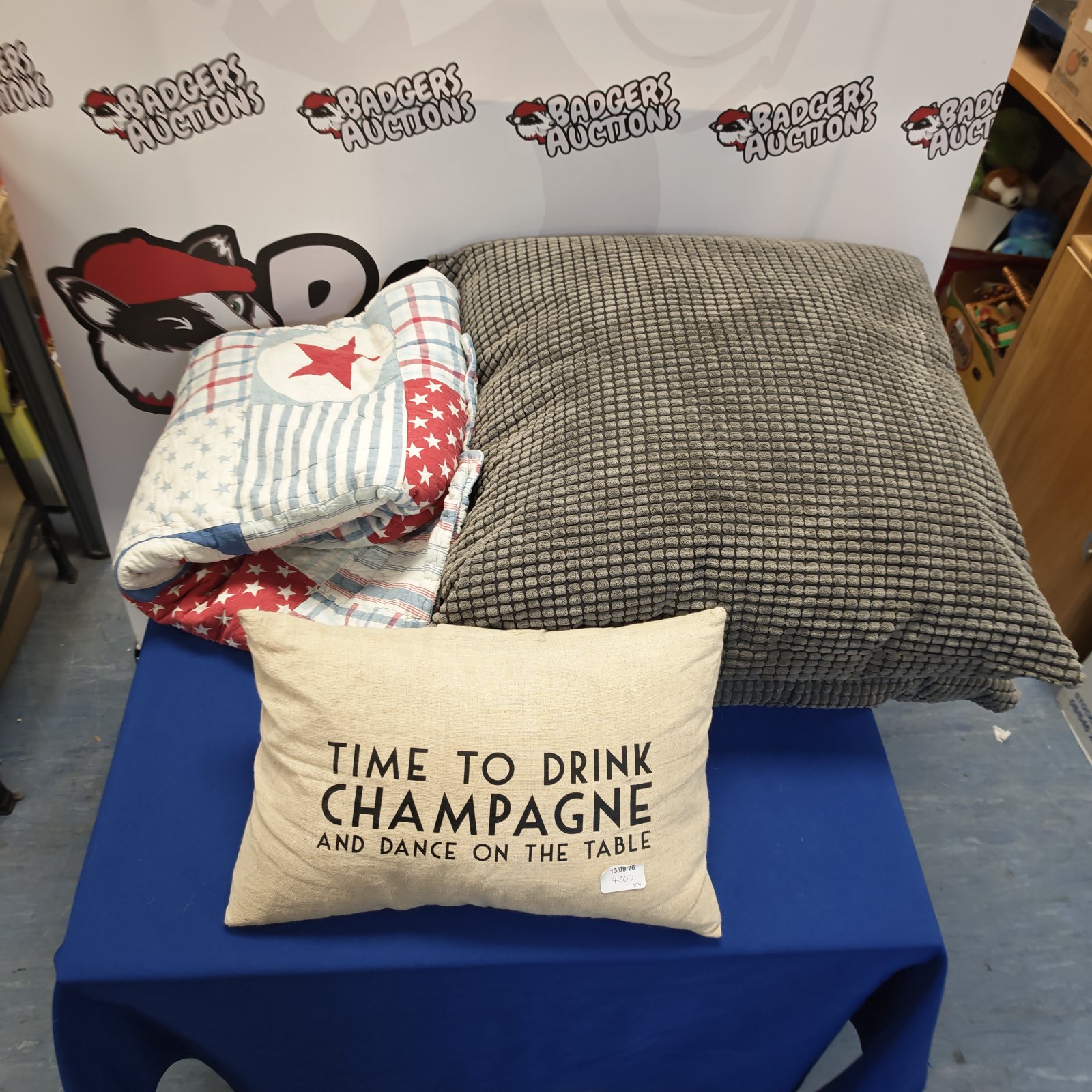 Cushion bundle featuring grey cushions, patchwork blanket and champagne cushion.