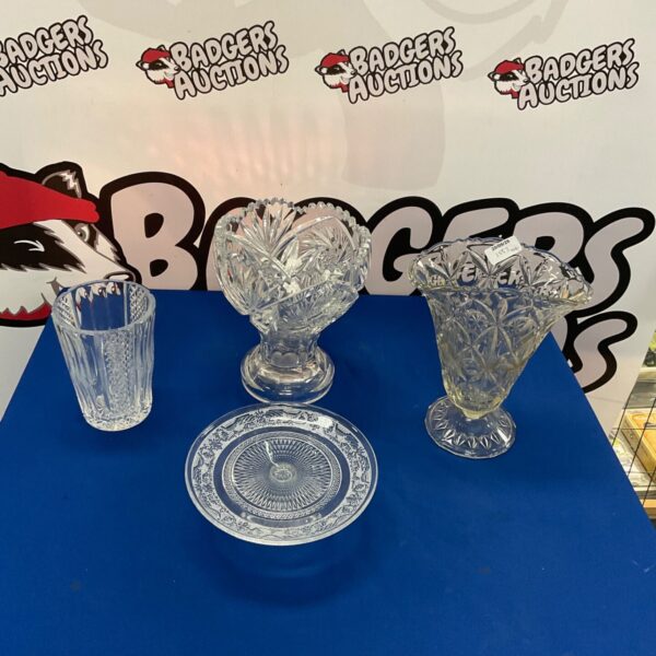 Vintage cut glass vases displayed on a patterned surface.