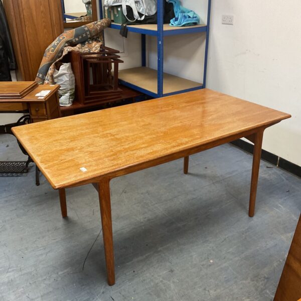 Mid-century Danish extending dining table in a room setting.