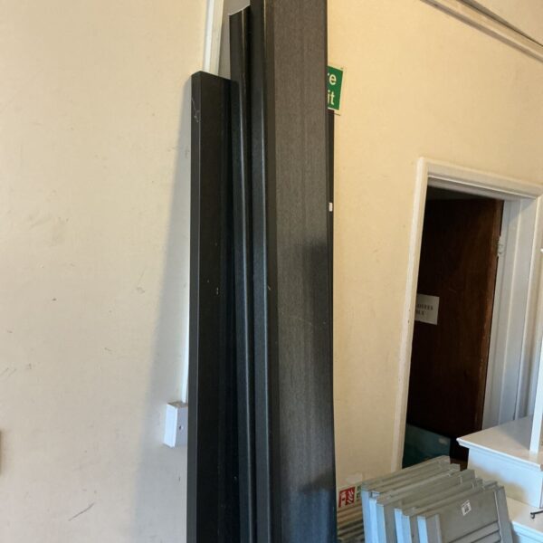 Dark plastic cladding section for wall covering.