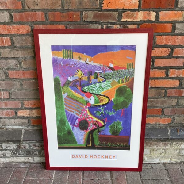 Large David Hockney landscape print in a colourful frame.
