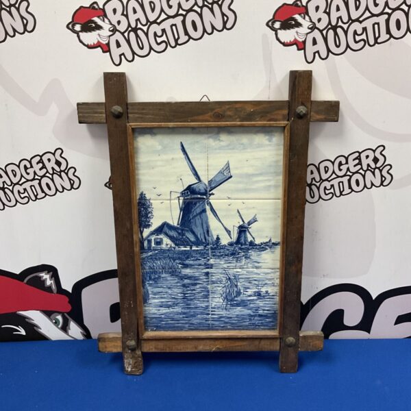 Vintage Delft Blauw tiles featuring a windmill scene in a wooden frame.
