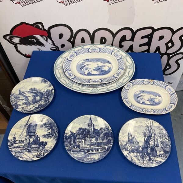Delft pottery plate with a windmill scene in blue and white.