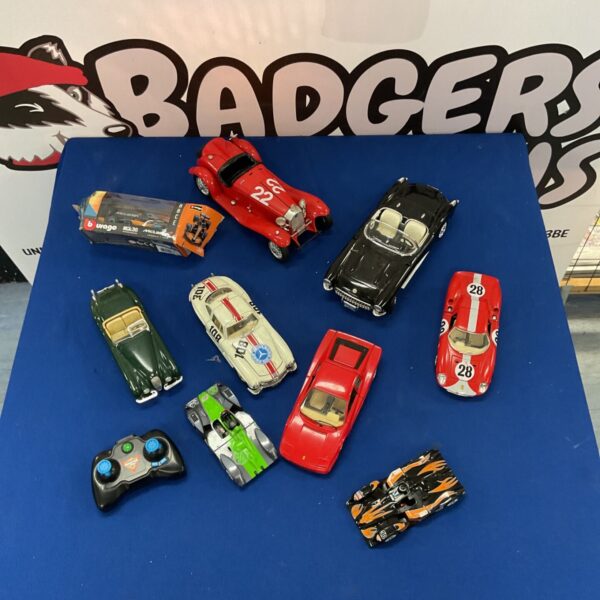 Diecast model car collection featuring Ferrari, Corvette, and Le Mans models.