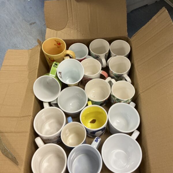 Box of assorted Disney character mugs for collectors.