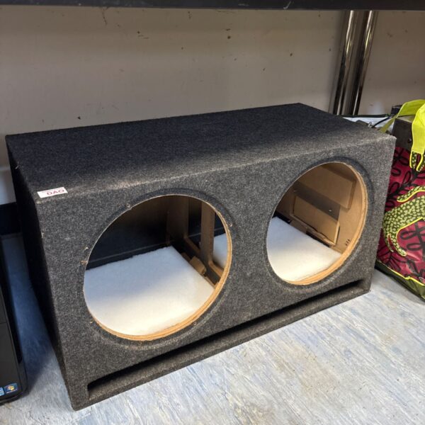Dark carpeted double subwoofer box with ports for powerful bass.