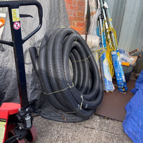 Roll of corrugated plastic drainage pipe for garden use.
