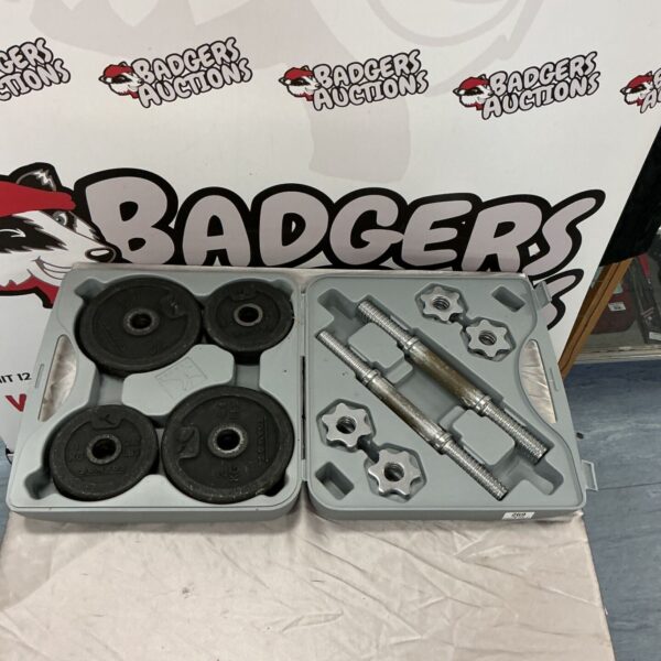 Metal dumbbell set with adjustable weights inside a plastic case.