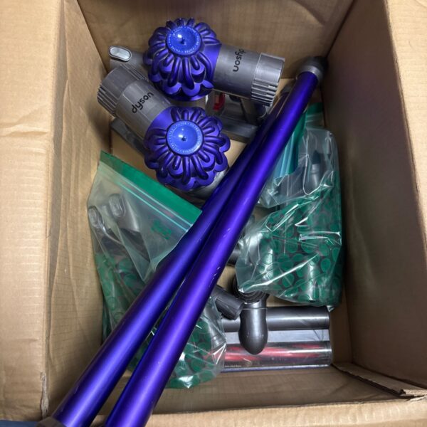 Box of Dyson cordless hoover parts for repair or collection.