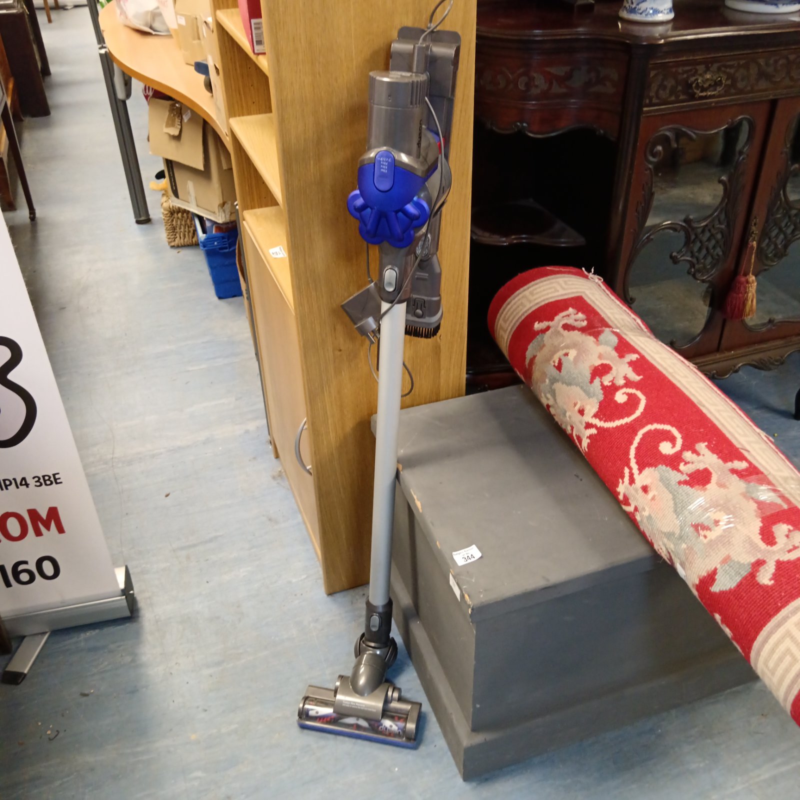 Dyson DC35 cordless vacuum cleaner with charger, ready for auction.