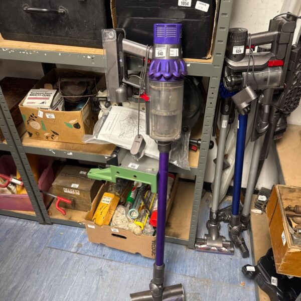 Dyson V10 Animal cordless vacuum cleaner with attachments.