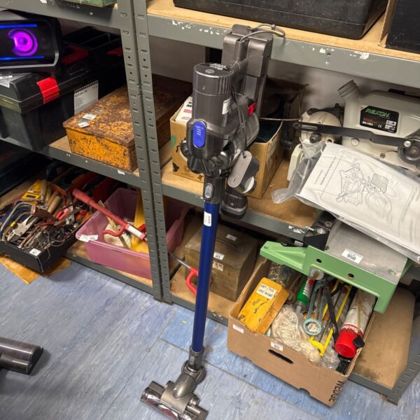 Dyson V8 Absolute cordless vacuum cleaner with charger, side view.