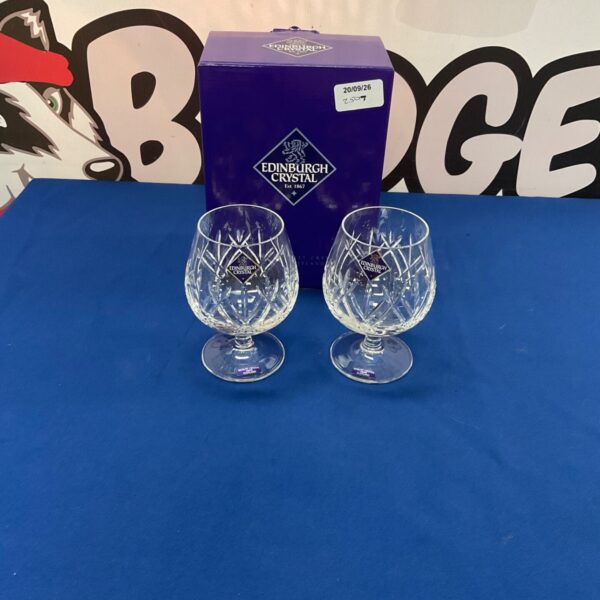 Pair of Edinburgh Crystal brandy glasses on a patterned surface.
