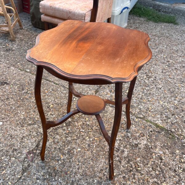Antique Edwardian mahogany two-tier occasional table with curved legs.